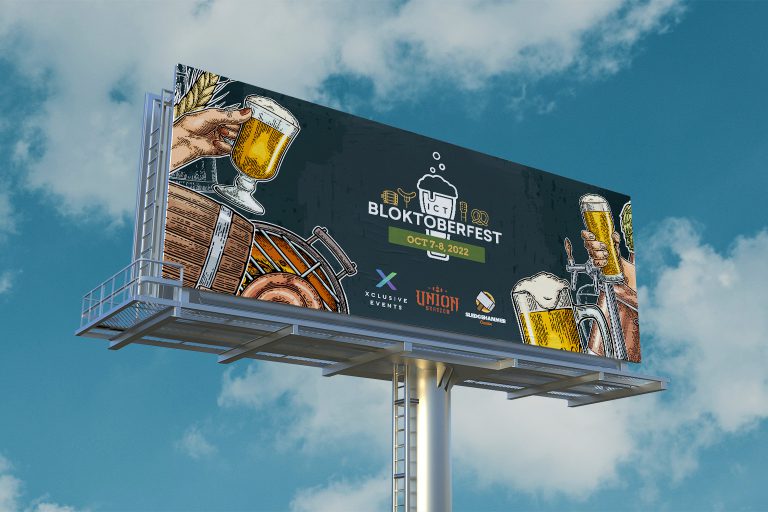 Bloktoberfest billboard with partly cloudy sky behind it.