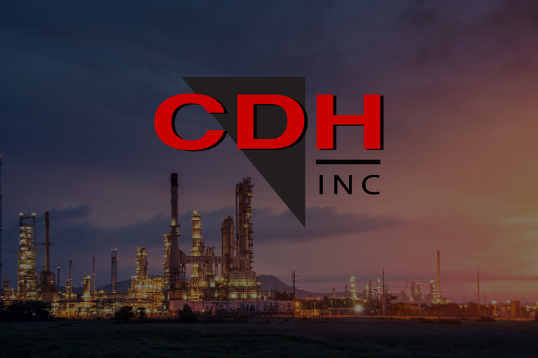 CD&H Inc. logo over a photo of a refinery at twilight.