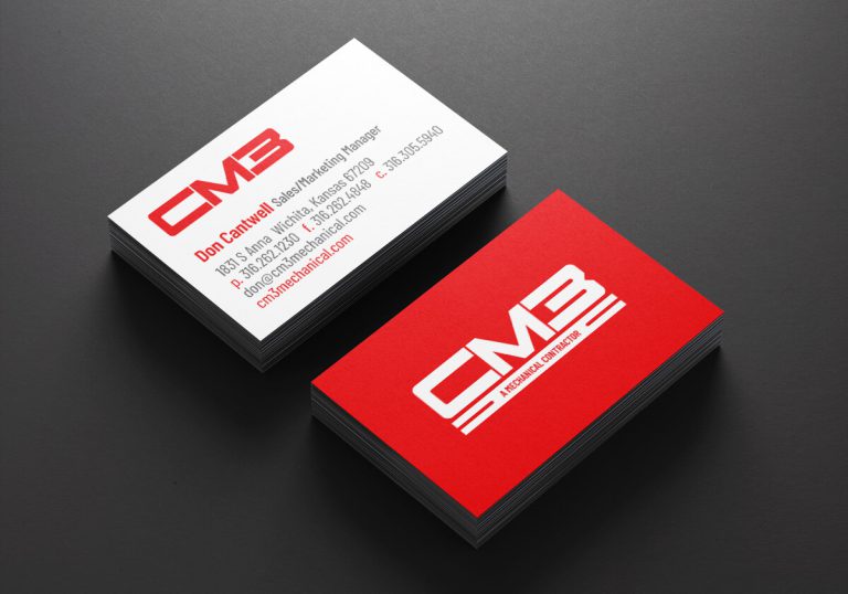 The front and back of the CM3 business cards displayed in a stack on a dark background.