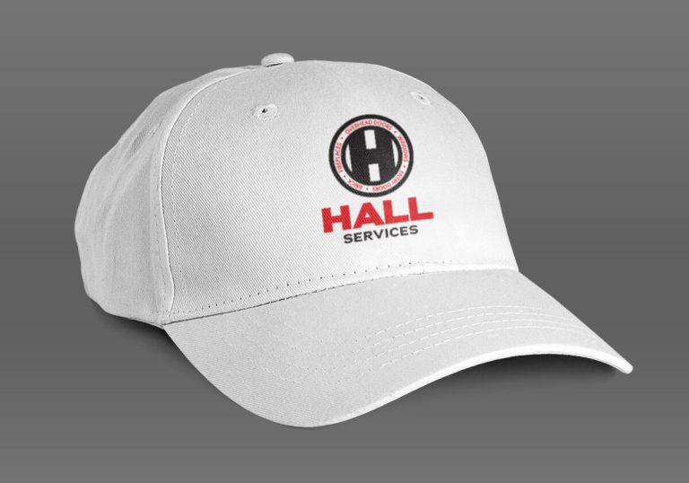 White ball cap with the Hall Services logo on it.