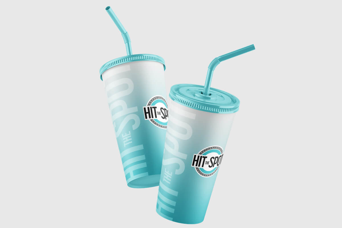 Teal and white Hit the Spot branded soft drink cups.