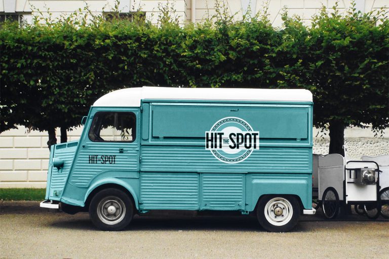 Teal food truck with Hit the Spot logo