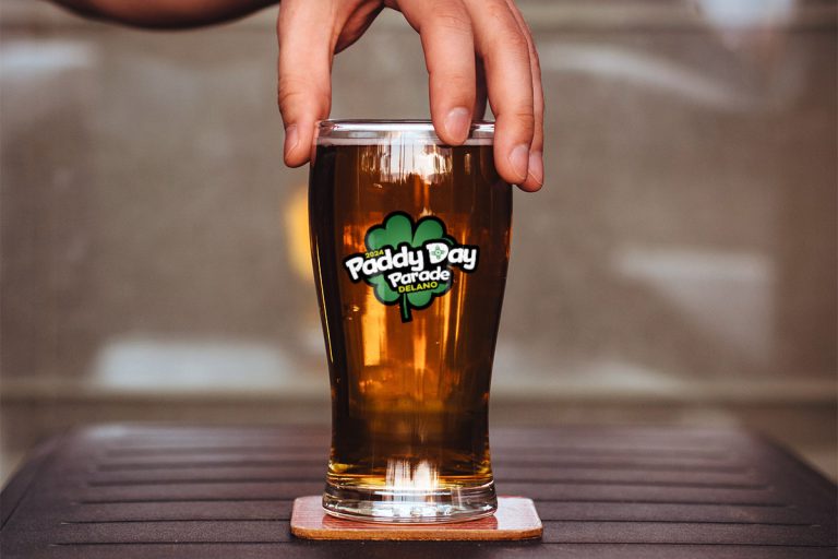 Delano Paddy Day Parade logo on a beer glass.