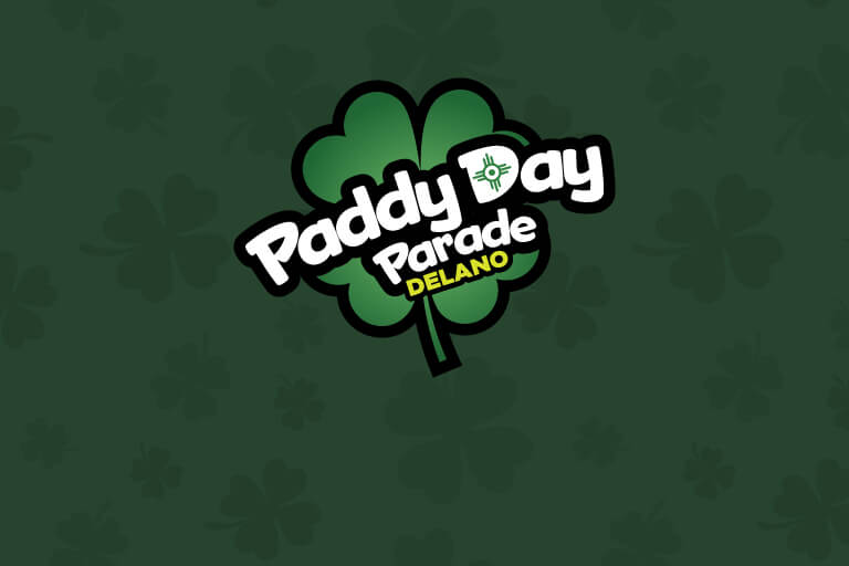 Delano Paddy Day Parade logo over dark green tartan background.