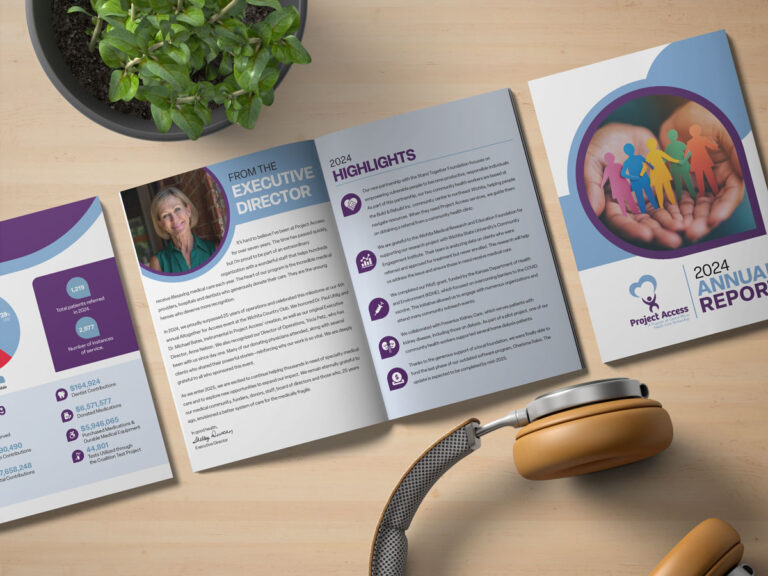 The Project Access 2024 Annual Report lays open on a wooden table. There is also a plant and a set of headphones.
